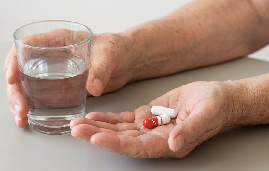 Senior citizen holding printed capsules